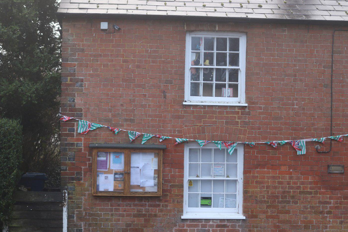 A village hall with bunting across its front
